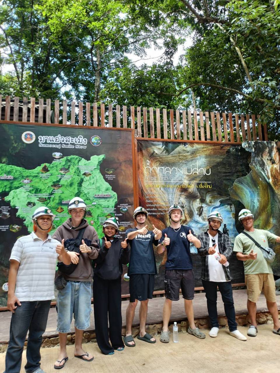 Tour group in helmets at the entrance map of Mae Sap Cave, Samoeng