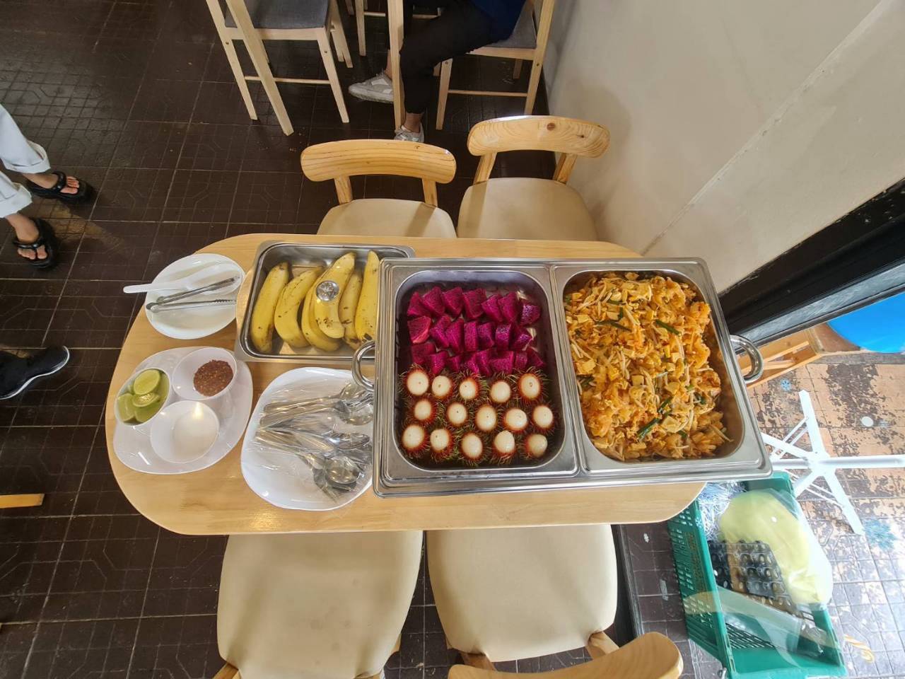 Lunch table set with pad thai, fruit and bananas for tour guests
